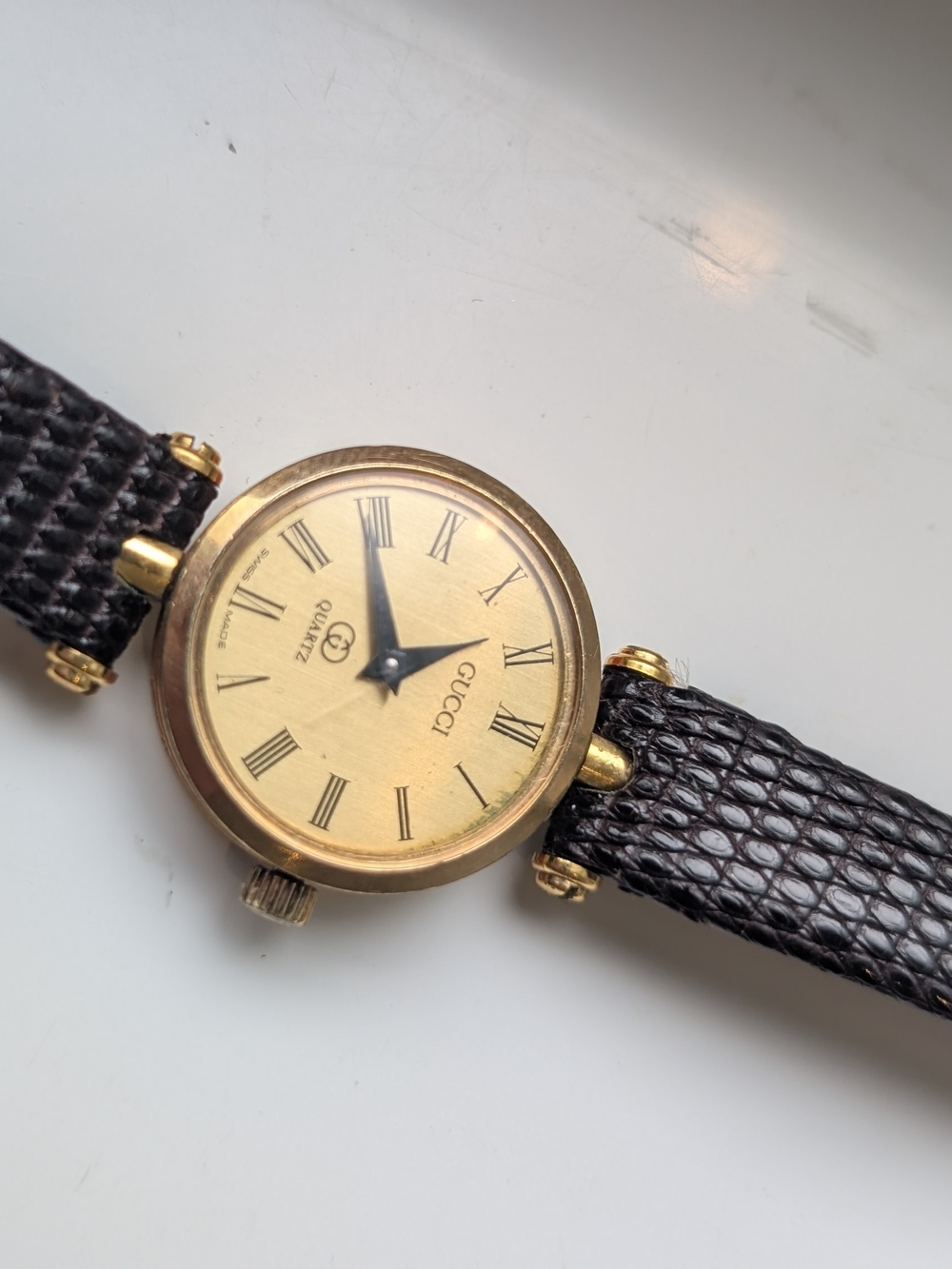Gucci Ladies Gold Dial Watch with Black Leather Strap